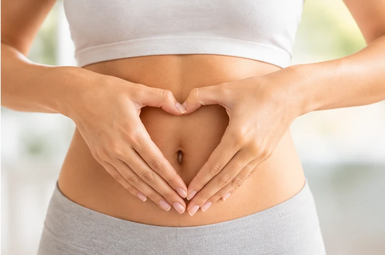 Hands forming a heart over the abdomen — fiber’s role in gut health and the microbiome
